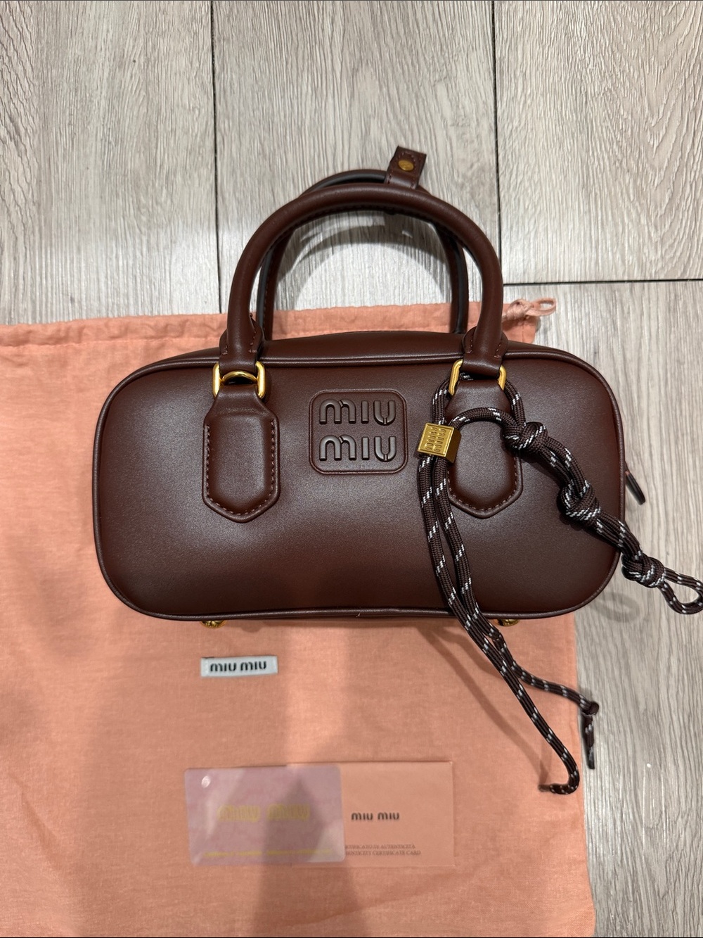 Logo brown leather bag with charm